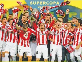  ?? Picture: AFP ?? TASTE OF GLORY. Athletic Bilbao players celebrate after winning the Spanish Super Cup on Sunday night.