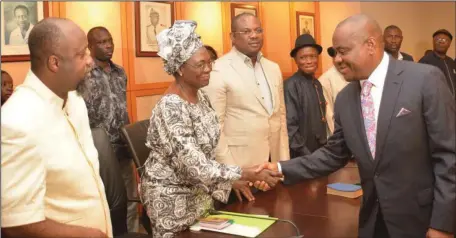  ??  ?? Rivers State Governor, Nyesom Ezenwo Wike (right), exchanging pleasantri­es with the widow of Captain Elechi Amadi, Preye, after the inaugurati­on of the state burial committee for Amadi by the governor at the Government House, Port Harcourt...yesterday