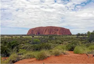  ?? ANDREW VOERMAN/STUFF ?? Uluru stands alone amongst a sea of nothing in the Outback.