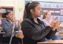  ?? MARK HOFFMAN / MILWAUKEE JOURNAL SENTINEL ?? Freshman Ashley Morales uses American Sign Language in class at La Follette High School in Madison.