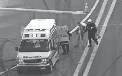  ?? ANDREW WEBER/USA TODAY SPORTS ?? NASCAR driver Justin Allgaier walks to the ambulance during the 2015 Daytona 500 at Daytona Internatio­nal Speedway.