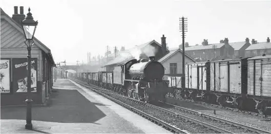  ?? J W Armstrong/ARPT ?? Heading away from Carlisle and making for the Newcastle District, Peppercorn ‘K1’ class 2-6-0 No 62030 brings a lengthy train of mineral empties through Haltwhistl­e station in the late afternoon of Saturday, 12 April 1952. Built by the North British Locomotive Co Ltd as Works No 26634, the pictured engine was new to Blaydon shed on 22 August 1949 and would continue to serve from there until a transfer to Gateshead on 6 May 1962; steam at Blaydon ceased from 16 June 1963. A North Eastern Region asset throughout its life, No 62030 would go on to serve from Alnmouth shed before concluding its career as a Sunderland engine in August 1965.