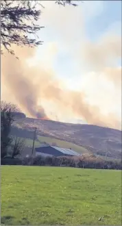  ?? ?? RIGHT: The scene outside Kildorrery on Tuesday, with extensive smoke coming from the nearby hillside. This is the second fire at the same location in a number of months and required six different units of the fire brigade to bring the wildfire under control.