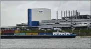 ??  ?? A container ship passes the Ford car plant in Cologne, Germany, as the U.S. car maker restarts the production after the coronaviru­s lockdown.