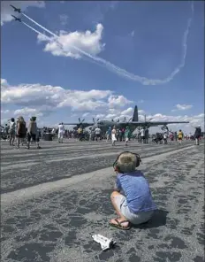  ??  ?? Asher Smolleck, 5, of Latrobe watches the U.S. Navy Blue Angels perform during the Westmorela­nd County Airshow on Sunday at Arnold Palmer Regional Airport.