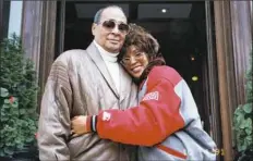  ?? Courtesy of The Estate of Whitney E. Houston ?? Whitney Houston with her father John, who, like her brothers, put himself on her payroll.