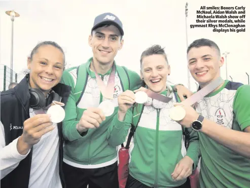  ??  ?? All smiles: Boxers Carly McNaul, Aidan Walsh and Michaela Walsh show off their silver medals, while gymnast Rhys McClenagha­n
displays his gold