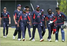  ?? AP PHOTO/KB MPOFU ?? United States cricket players walk off the pitch after beating Singapore by 132 runs in a cricket World Cup qualifier match in Bulawayo, Zimbabwe, Tuesday, July, 12, 2022. The U.S. has advanced to the semifinals in Zimbabwe of a qualifying tournament for the T20 World Cup in Australia in October. One more win, and the Americans are in.