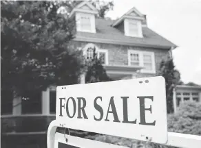  ?? MATT ROURKE / THE ASSOCIATED PRESS FILES ?? Crown corporatio­n CMHC says it expects higher interest rates, stricter mortgage rules and a slowing economy will further dampen demand for housing over the near term.