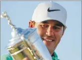  ??  ?? Brooks Koepka poses with the trophy after winning the U.S. Open golf tournament in Erin, Wis.