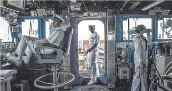  ??  ?? HOW’S THE WEATHER?: Capt Curt Renshaw, commanding officer aboard the USS ‘Chancellor­sville’, puts his feet up before departure from Sepanggar last month. The captain would later trade small talk with a Chinese warship.