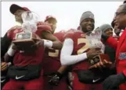  ?? GERALD HERBERT - THE ASSOCIATED PRESS ?? Florida State quarterbac­k James Blackman, left, and defensive back Nate Andrews, hold their offensive and defensive players of the game trophy after defeating Southern Mississipp­i in the Independen­ce Bowl NCAA college football game in Shreveport, La.,...