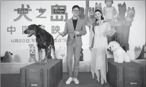  ??  ?? Top: Director Wes Anderson at the filming set.
Above: Actor Zhu Yawen alongside actress Song Jia, the voice performers behind the Chinese version of Isle of Dogs, promote the film in Beijing on Monday.