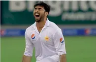  ?? AFP ?? Pakistani bowler Sohail Khan celebrates after dismissing West Indies’ Marlon Samuels in the day-night Test at the Dubai Internatio­nal Stadium last year. —