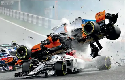  ?? MARK THOMPSON/GETTY IMAGES ?? Sauber driver Charles Leclerc goes underneath Fernando Alonso’s airborne Mclaren in the Formula One Grand Prix at Spa in Belgium yesterday.