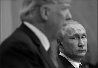  ?? PABLO MARTINEZ MONSIVAIS / ASSOCIATED PRESS FILE (2018) ?? Vladimir Putin, right, looks toward then-president Donald Trump as Trump speaks during their joint news conference July 16, 2018, at the Presidenti­al Palace in Helsinki, Finland.