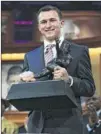  ?? HEISMAN TRUST ?? Johnny Manziel grasps his trophy on Saturday night after the QB became the first freshman to win the Heisman.