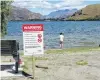  ?? PHOTO: TRACEY ROXBURGH. ?? Ill water . . . Signs at Lake Hayes in February warning of cyanobacte­ria.