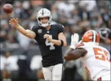  ?? D. ROSS CAMERON - THE ASSOCIATED PRESS ?? FILE - In this Sunday, Sept. 30, 2018 file photo, Oakland Raiders quarterbac­k Derek Carr (4) passes against Cleveland Browns linebacker Genard Avery (55) during overtime of an NFL football game in Oakland, Calif. The game between the Raiders (1-6) and the 49ers (1-7) this week has a legitimate argument of being the worst prime-time game in NFL history.