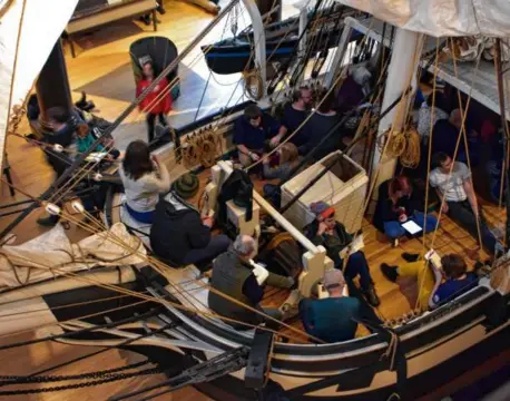  ?? KRISTEN ELWORTHY ?? Readers in the New Bedford Whaling Museum’s whaling ship replica at the 2022 Moby-Dick Marathon.