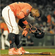  ?? Santiago Mejia / The Chronicle ?? Andrew McCutchen takes off his batting equipment after striking out, one of nine strikeouts by Colorado pitchers.