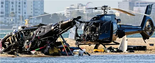  ?? ?? Destructio­n: The wreckages including, left, the helicopter whose passengers died after it crashed upside-down