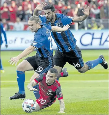  ?? STAN BEHAL/TORONTO SUN ?? Toronto FC’s Sebastian Giovinco is taken down by the Montreal Impact’s Samuel Piette and Victor Cabrera at BMO Field yesterday. Giovinco, who was starting for the first time in more than a month, had plenty of rust to his game, writes Kurtis Larson.