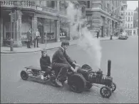  ?? PICTURES: MAEERS/ FOX PHOTOS/ GETTY IMAGES ?? READY TO ROLL: From top, a steam roller on Rushcombe Hill in Gloucester­shire, May 1933; a steam traction engine with a broken rear axle in Pall Mall, London, November 1923; a traction engine pulling an all metal barge on the road to London, February 1936; Jonathan Minns delivers his Edwardian traction engine to Christie’s for auction, London, in July 1967. Ten- year- old Paul Walter, son of a Christie’s saleroom employee, travels as a passenger.