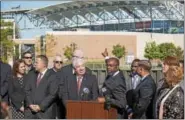  ?? RICK KAUFFMAN — DIGITAL FIRST MEDIA ?? Chester Mayor Thaddeus Kirkland, center, gestures to Talen Energy Stadium, saying that Chester is the perfect location for Amazon headquarte­rs, citing its proximity to highways, waterways, railroad lines and the airport.