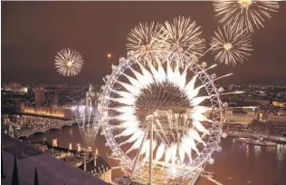  ?? PHOTO: GETTY IMAGES ?? What a blast . . . Fireworks explode over The London Eye and Elizabeth Tower near Parliament as thousands of revellers gather along the banks of the River Thames to ring in the new year in London, England yesterday.