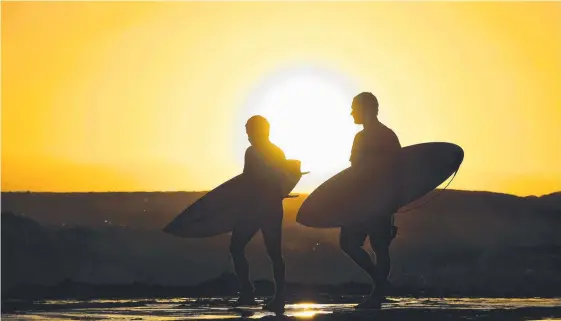  ?? Picture: AAP IMAGE ?? Surfers prepare to enter the water at Snapper Rocks on the Gold Coast.