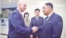  ??  ?? Infantino (L) shakes hands with Kim Jang San (R), secretary general of North Korean Football Associatio­n, upon his arrival at Pyongyang internatio­nal airport in Pyongyang on October 15, 2019. - AFP photo