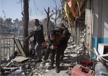  ??  ?? File photo shows Afghan volunteers carry a victim at the scene of a car bomb explosion in front of the old Ministry of Interior building in Kabul. — AFP photo