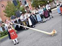  ?? JESI YOST — FOR MEDIANEWS GROUP ?? Veronica Schoellkop­f plays her Alpine Horn as her granddaugh­ter, ViVi, holds the music over the weekend at Building a Better Boyertown’s 14th annual Oktoberfes­t.