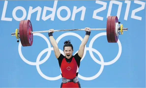  ?? HASSAN AMMAR/THE CANADIAN PRESS ?? Canadian weightlift­er Christine Girard has become an Olympic gold medallist with her bronze at the London 2012 Games upgraded because the two athletes ahead of her flunked drug tests. She’s also been awarded a bronze from 2008 due to another failed test.