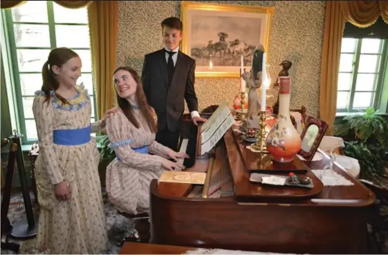  ?? IAN STEWART, SPECIAL TO THE RECORD ?? Actors Kate Gayman, left, Breanne Tice, and Graeme Currie pose for a scene at Woodside national historic site on Monday. The three will portray the young William Lyon Mackenzie King and his two sisters in Stephen Young’s play Secret, which opens June 8.