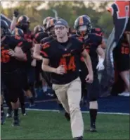  ?? CHERYL HALL, CLEEPOTOME­MORIES.COM - COURTESY NORTH OLMSTED ATHLETICS ?? North Olmsted’s Samer Babi runs onto the field prior to a game. Babi is the recipient of the Cleveland Clinic Courage Award.