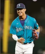  ?? John Froschauer / Associated Press ?? The Seattle Mariners’ Julio Rodriguez smiles as he jogs off the field against the Cleveland Guardians on Friday in Seattle.