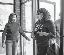  ?? PHOTOS COURTESY SENTARA HEALTHCARE ?? Left: Iris Lundy, director of health equity for Sentara, greets people at the door at a COVID-19 vaccinatio­n clinic in Norfolk on Feb. 25, immunizing minority groups, some of whom have been disproport­ionately impacted by the pandemic. Sentara has partnered with church pastors to do the outreach. Right: A woman receives her vaccine at a church.