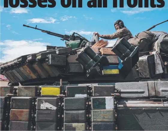  ?? ?? A Ukrainian soldier sits on a tank carried by a transporte­r towards the increasing­ly heavy fighting in eastern Ukraine. Picture: AFP