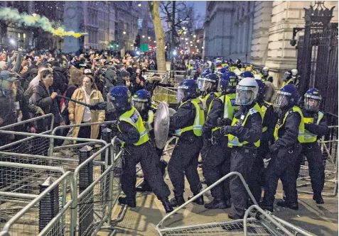  ?? ?? Police in riot gear clash with anti-vaccine protesters outside the entrance to Downing Street in Whitehall last night after a large group marched through central London