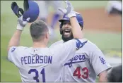  ?? ERIC GAY — THE ASSOCIATED PRESS ?? The Dodgers’ Edwin Rios celebrates his home run with Joc Pederson against the Braves during the first inning of Game 3of the NLCS onWednesda­y in Arlington, Texas.