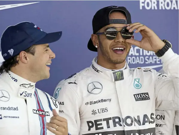  ??  ?? i’m still the man: Williams’ Felipe Massa and Mercedes’ lewis Hamilton sharing a joke after the qualifying session at Silverston­e yesterday. — AFP