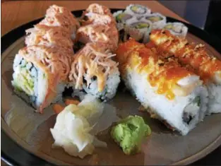  ?? MARK KOESTNER — THE NEWS-HERALD ?? A couple of different types of rolls are displayed at Young’s Sushi Bar in Madison.