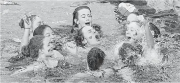  ?? Jason Fochtman ?? The Woodlands girls swim team celebrates its Class 6A state title Saturday in Austin. The Lady Highlander­s topped Austin Westlake in the final race — the 400-yard freestyle relay — to secure the crown.