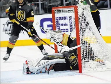  ?? Chase Stevens Las Vegas Review-journal @csstevensp­hoto ?? Golden Knights goaltender Marc-andre Fleury falls back into the net while trying to stop a goal by the Arizona Coyotes in the third period Tuesday at T-mobile Arena. Arizona scored three goals in the third for a 5-2 victory.