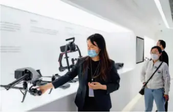  ??  ?? A staff member introduces DJI’S latest innovation­s at the Chinese commercial drone manufactur­er’s head office in Shenzhen.