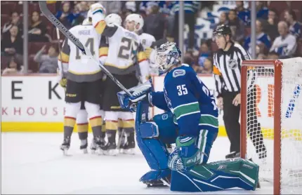  ?? The Canadian Press ?? Vancouver Canucks goalie Thatcher Demko reacts as the Vegas Golden Knights celebrate their ninth goal during the third period of Sunday’s pre-season NHL game in Vancouver. The Canucks lost 9-4.