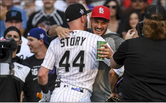  ?? AARON ONTIVEROZ — THE DENVER POST ?? Colorado’s Trevor Story hugs former teammate Nolan Arenado during the MLB Home Run Derby at Coors Field in 2021.