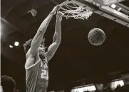  ?? Evert Nelson / Associated Press ?? Texas senior forward Jericho Sims had his first double-double in the Longhorns’ win at Kansas.